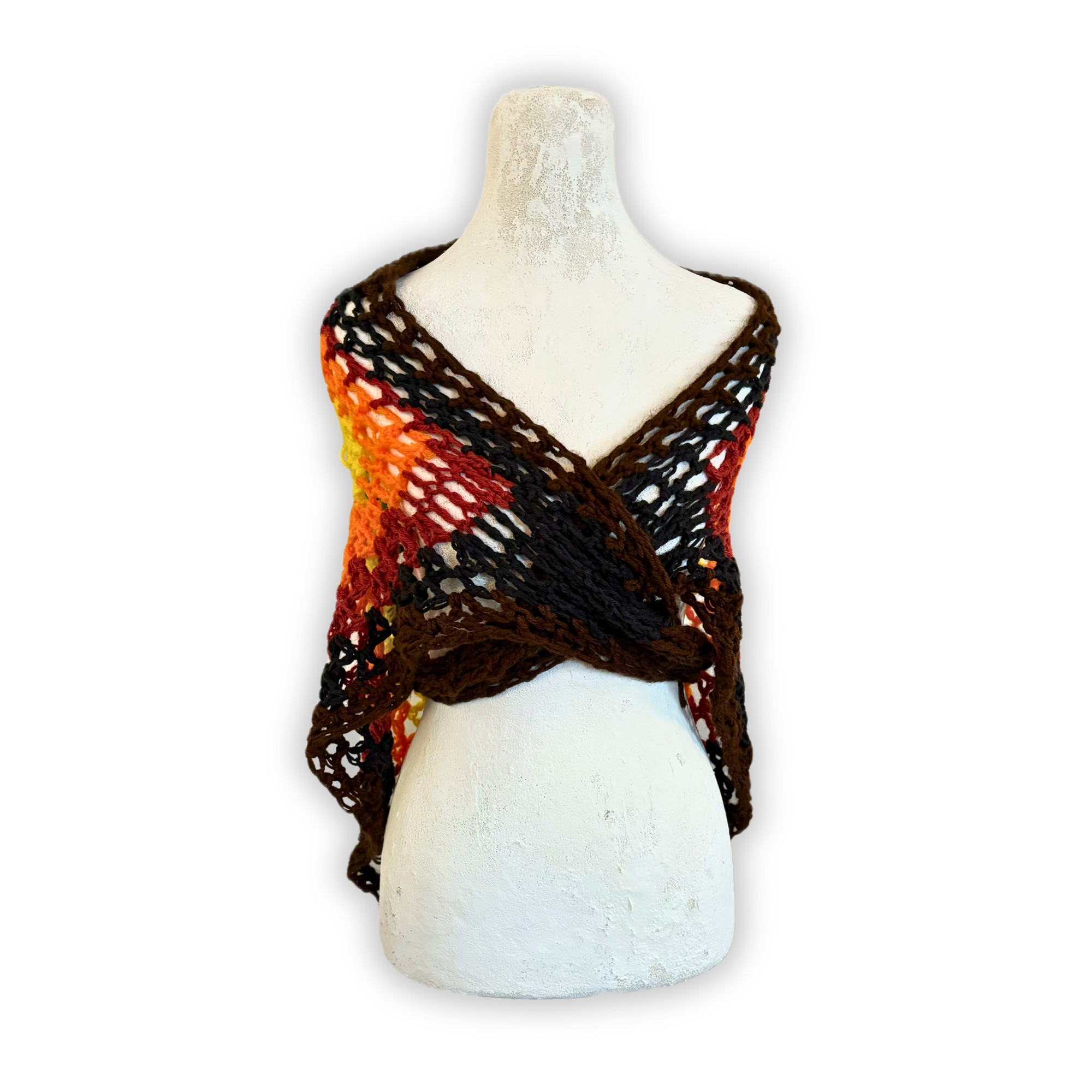 Mannequin wearing a colorful knitted shawl on a white background