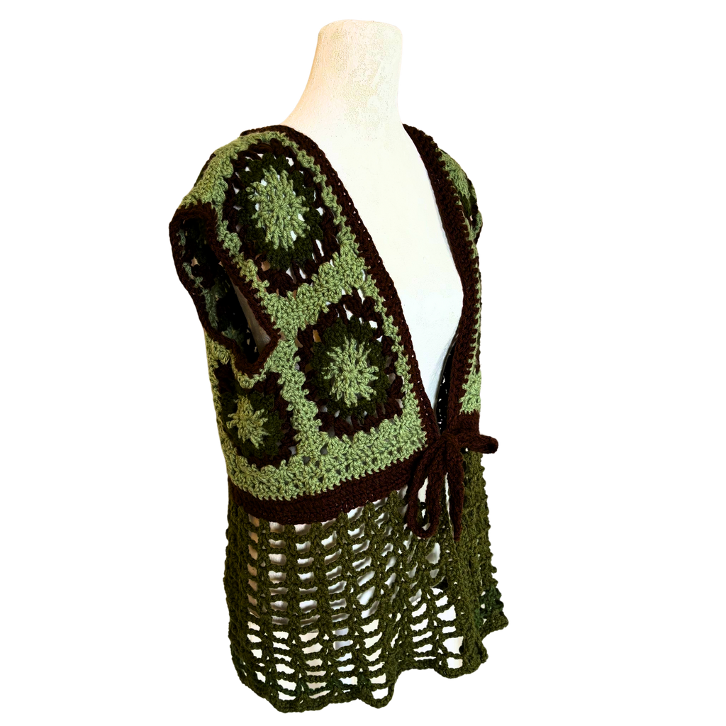 Green and brown crocheted vest on a mannequin against a white background
