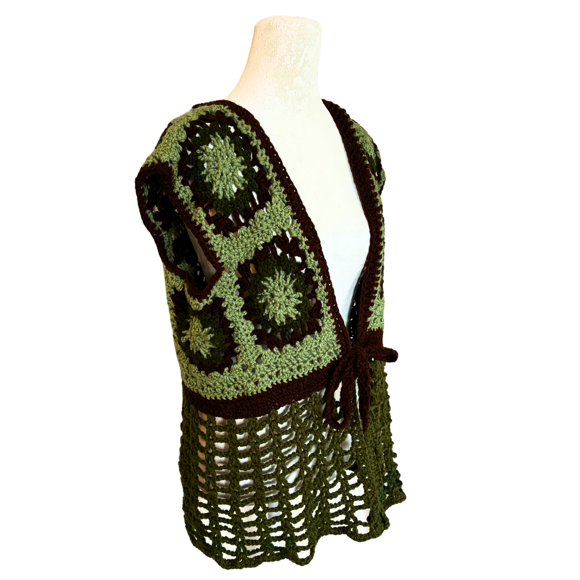 Green and brown crocheted vest on a mannequin against a white background