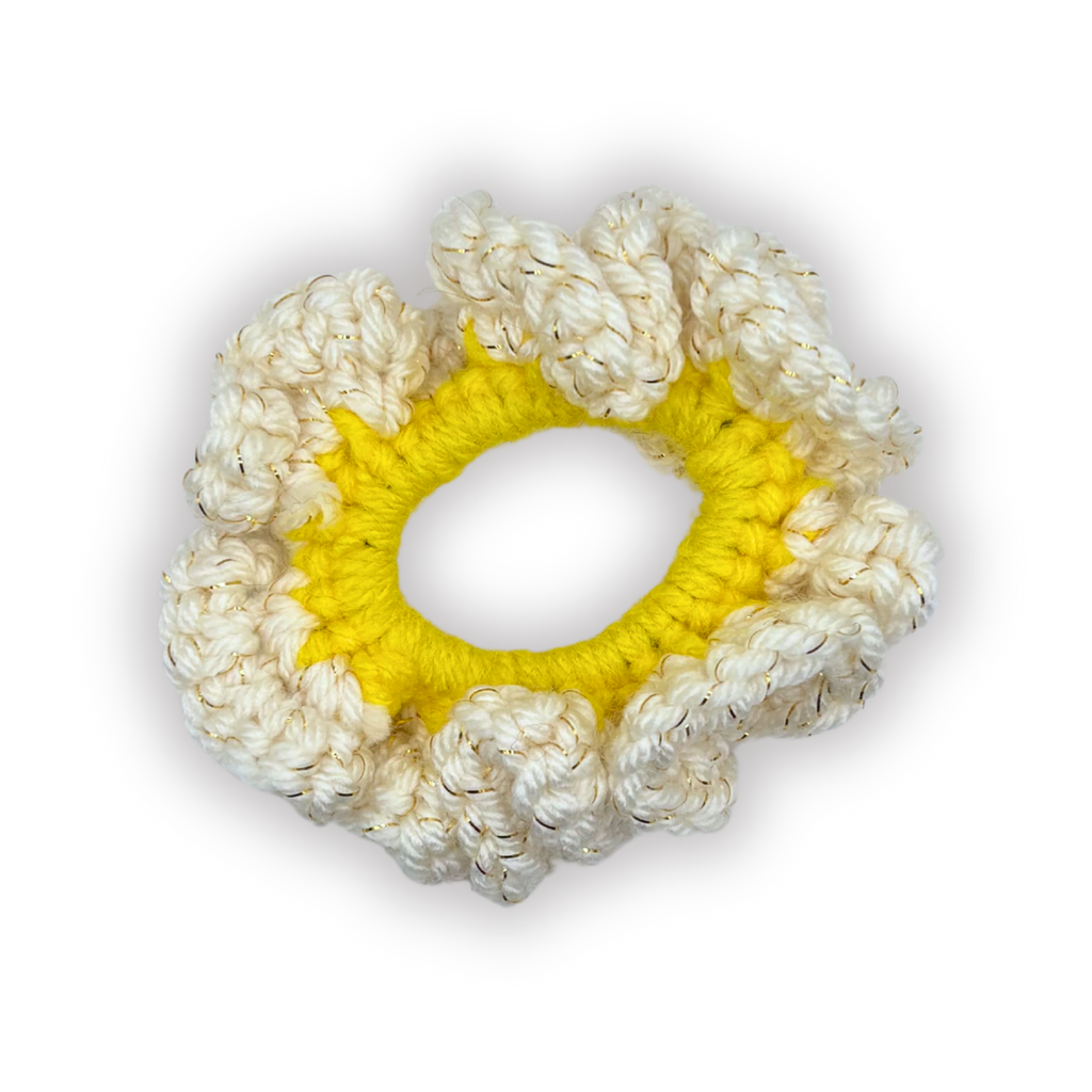 Crocheted scrunchie with yellow center and white outer ring on a white background