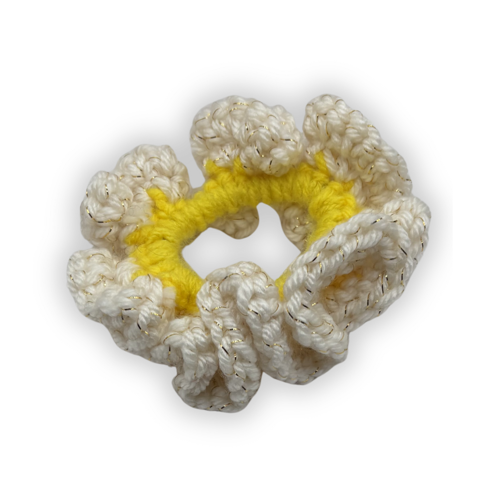 Crocheted scrunchie with a yellow center on a white background