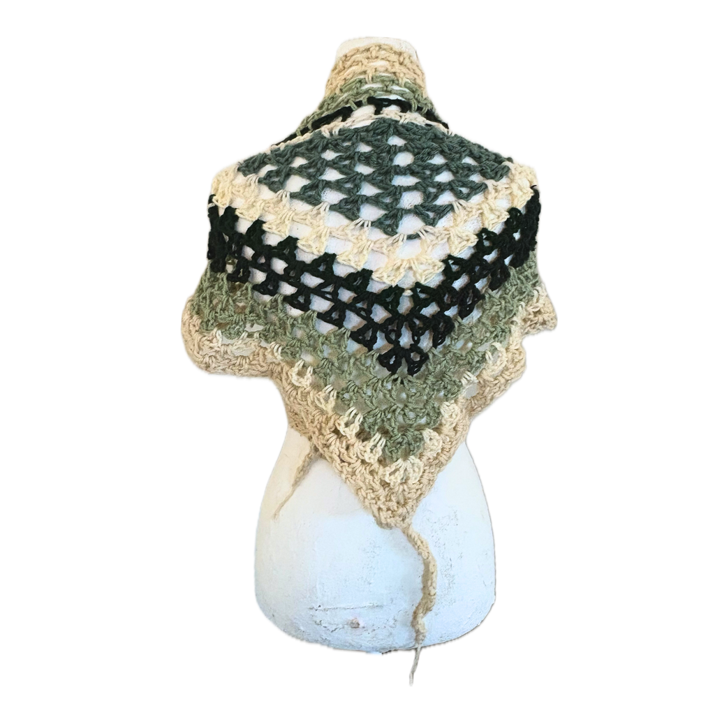 Crocheted  shawl with green and  beige pattern on a white background