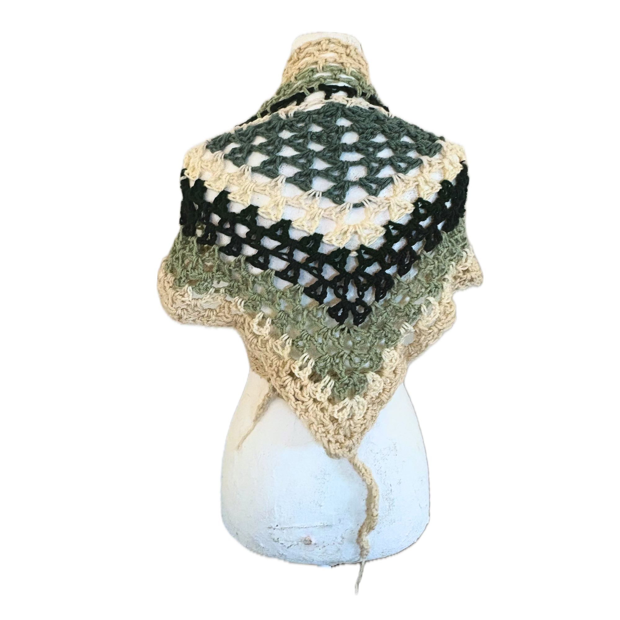 Crocheted  shawl with green and  beige pattern on a white background