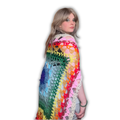 Woman wearing a colorful crocheted shawl on a white background